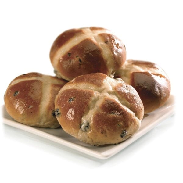 four freshly baked greenhalghs special hot cross buns placed on top of each other