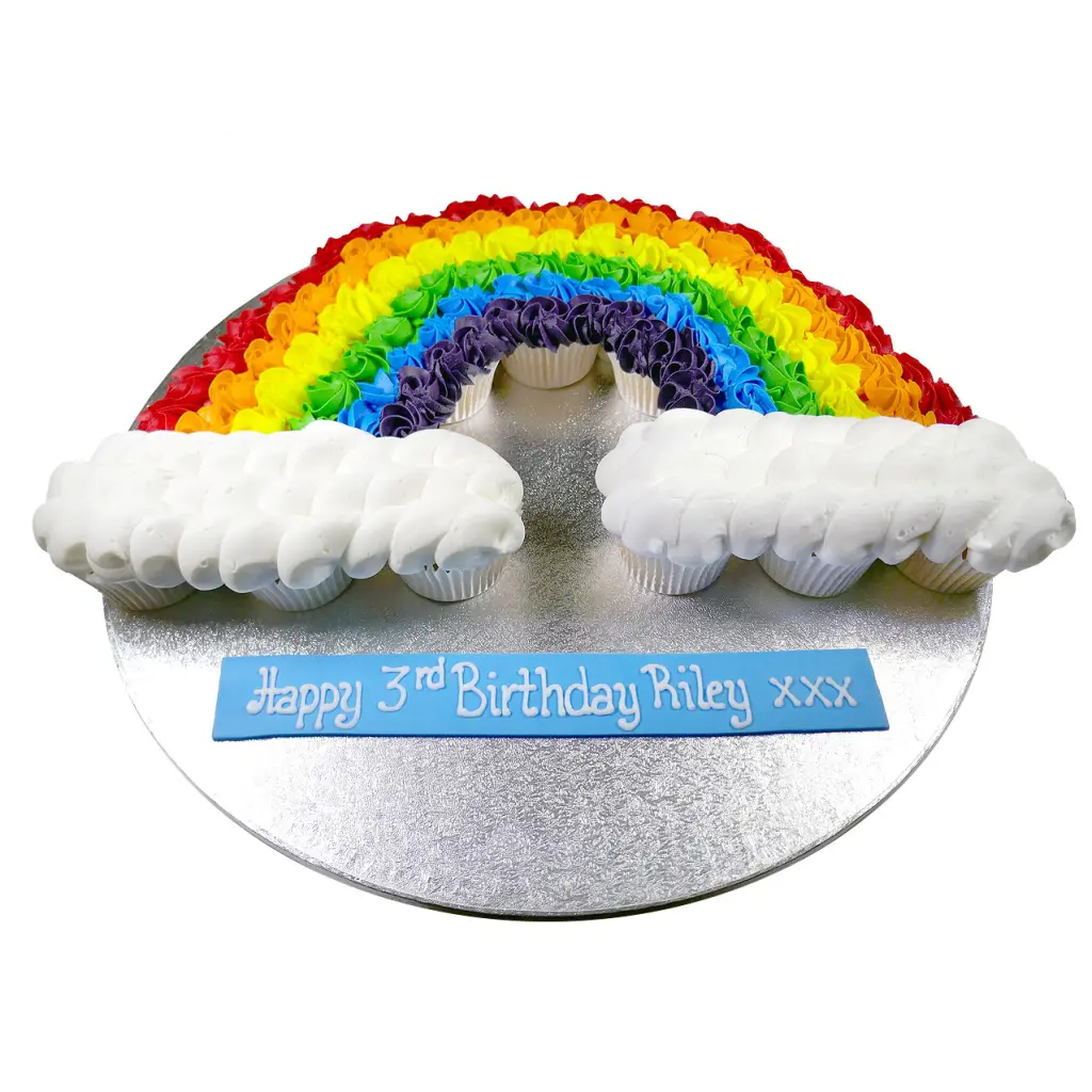 multicolour rainbow birthday celebration cupcakes in the shape of a rainbow and clouds made up of different colour cupcakes
