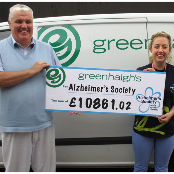 David handing over a cheque to the alzheimers society