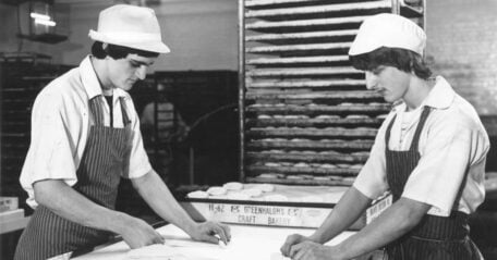black and white photo of 2 workers in the bakery
