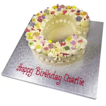 large sweety letter celebration cake topped with sweets