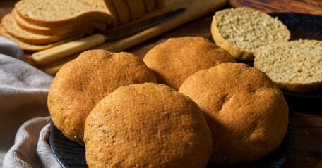 Freshly baked low-carb bread loaf with a golden crust, showcasing its delicious texture and color.