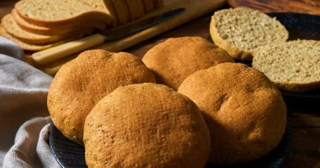 Freshly baked low-carb bread loaf with a golden crust, showcasing its delicious texture and color.