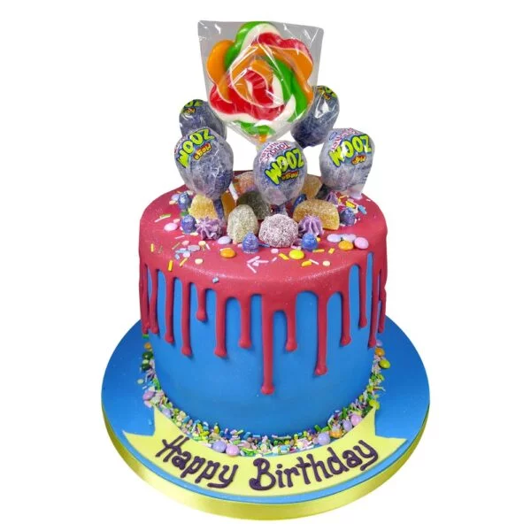 blue and red sugar pop celebration cake topped with different sweets and lolly pops
