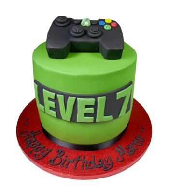 green gamer celebration cake with a black Xbox controller made from sugar paste