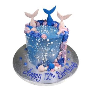 blue magical mermaid celebration cake topped with sugar paste shells and pearls