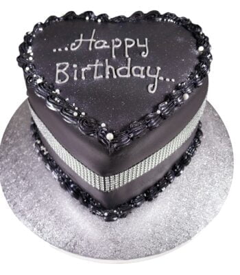 tall midnight heart celebration cake with a silver ribbon and a silver inscription saying happy birthday