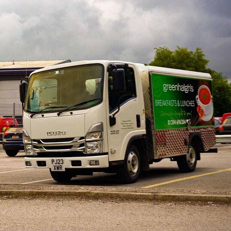 Greenhalghโs sandwich van fully stocked with fresh sandwiches and snacks, catering a wedding event.