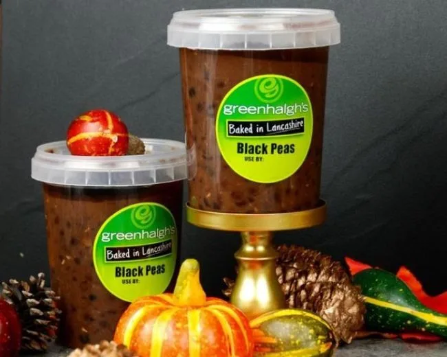 Black-Peas-Tub-500ml Two tubs of Greenhalgh's Baked in Lancashire Black Peas, 500ml, styled with pumpkins, gourds and pine cones